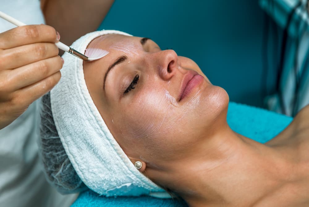 Client receiving a professional chemical peel treatment at Skin Social in Sandy Springs, GA, representing the start of proper chemical peel aftercare for glowing, rejuvenated skin.